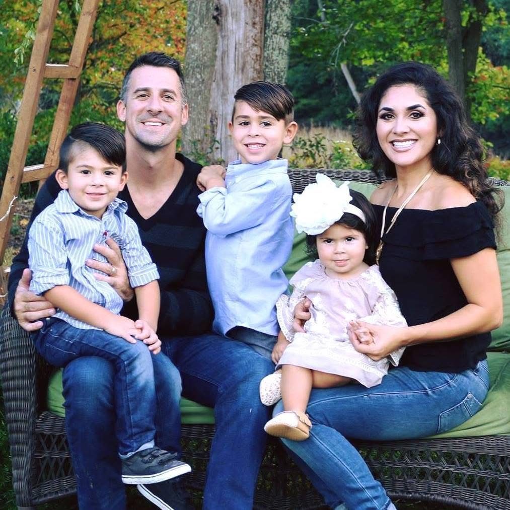 Mike and Vania with their three children on a garden bench