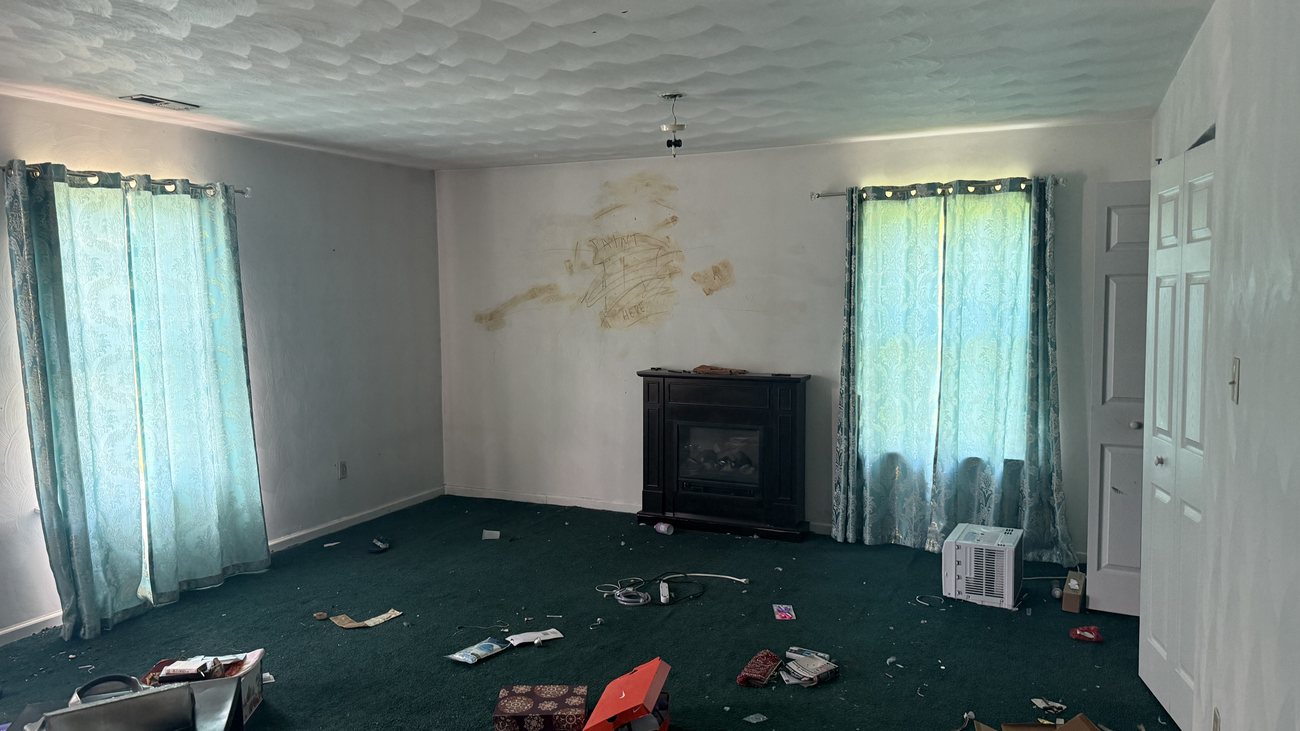 An empty, dated living room in a house we bought as-is