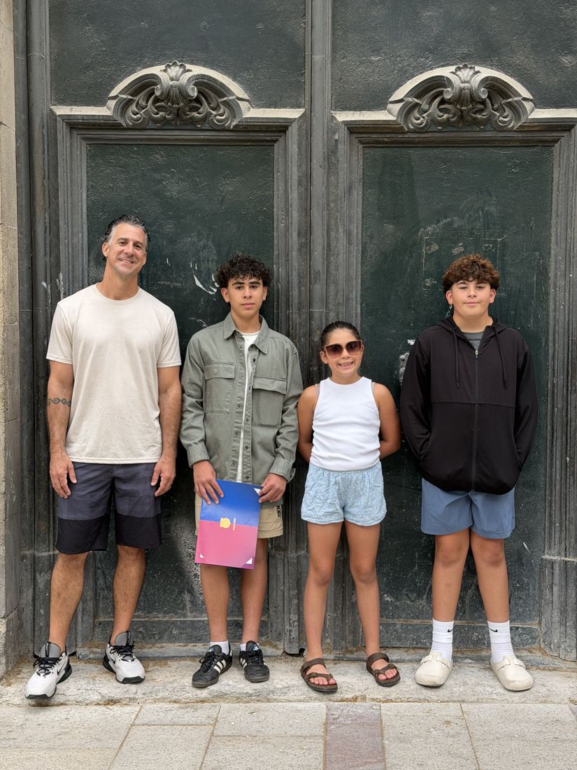 Mike and the kids in front of an old wooden door